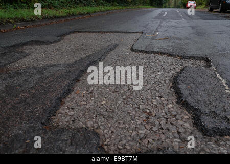 Dangerous deep large Potholes on road Stock Photo