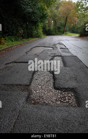 Dangerous deep large Potholes on road Stock Photo