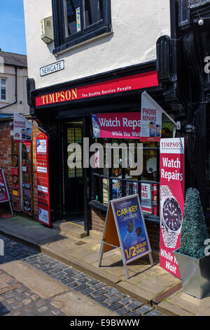 Entrance door of a Timpson store shop in York. Timpson stores repair watches and shoes and cut keys amongst other things. Stock Photo
