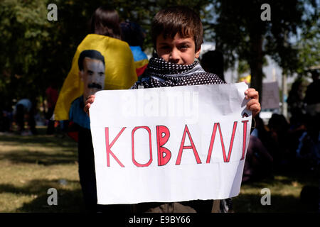 A young Kurdish boy holds a paperboard sign which reads 'Kobani' during a Kudish rally in support of Syrian Kurds suffering from ISIS attacks in the Syrian city of  Kobane.in the Kurdish city of Arbil Northern Iraq Stock Photo