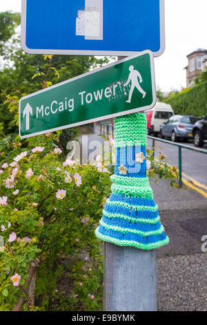 Yarn bombing, knitted sleeve around a lamppost in Oban Stock Photo