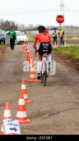 DORDRECHT, NETHERLANDS - APRIL 13 2013: Run Bike Run Bike Run duathlon event organized by TVD. A contender, Jacobs cycling away. Stock Photo