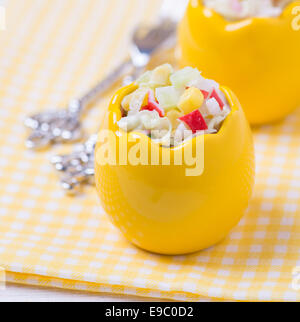 Fresh vegetable salad with corn, cabbage, crab and mayonnaise in egg-shaped bowls, selective focus Stock Photo