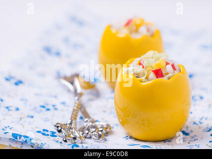 Fresh vegetable salad with corn, cabbage, crab and mayonnaise in egg-shaped bowls, selective focus Stock Photo