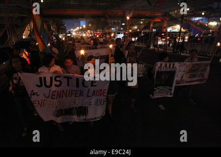 Manila, Phillipines. 24th October, 2014. Activists hold torches as they call for justice during a protest rally in Manila, Philippines on October 24, 2014. The protesters demanded justice for Filipino transgender Jeffrey Laude who was allegedly killed by US Marine Private First Class Joseph Scott Pemberton. Credit:  Rouelle Umali/Xinhua/Alamy Live News Stock Photo