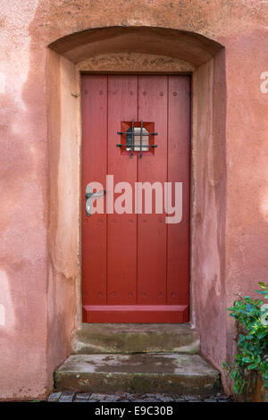 Narrow red brown wooden door Stock Photo