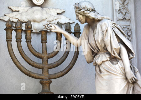 Sculpture with candlestick inside the Recoleta monumental cemetery. Buenos Aires, Argentina. Stock Photo