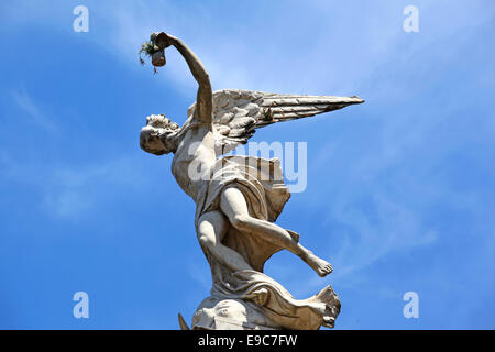 Statue of an angel with flowers inside the Recoleta monumental cemetery. Buenos Aires, Argentina. Stock Photo