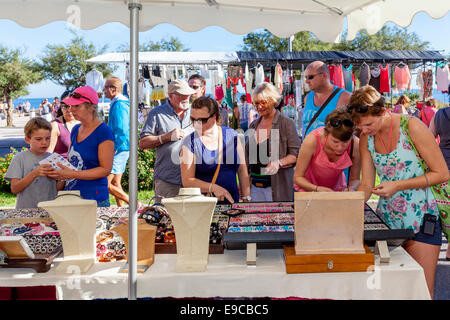 Tourists Shopping For Jewellery and Bracelets At The Friday Market In Ca'n Picafort, Mallorca - Spain Stock Photo