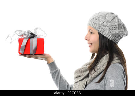 Close up Smiling Middle Age Woman in Side View Wearing Gray Winter Fashion Showing Small Red Present on Hand, isolated on White Stock Photo