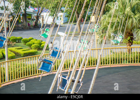 Spinning swings without people at carnival fair Stock Photo