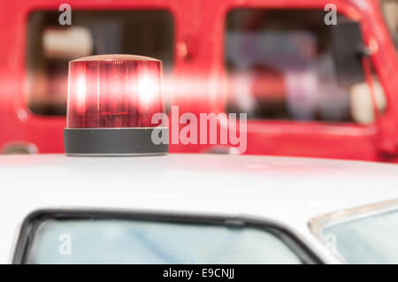 Detail of Flashing Red Siren Light on Roof of Emergency Vehicle Stock Photo