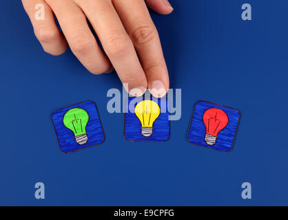Three light bulbs on blue background with woman's hand. Pictures drawn by me. Stock Photo