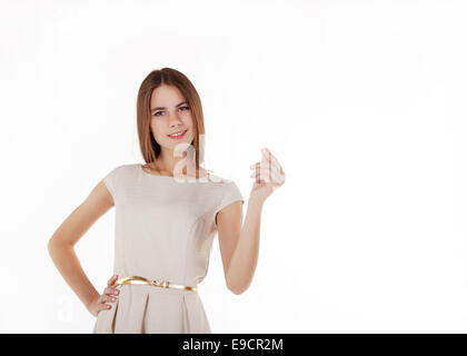 young beautiful girl in a bright dress holding an imaginary credit card Stock Photo