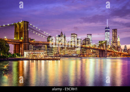New York, New York, USA city skyline with the Brooklyn Bridge and Manhattan Financial District over the East River.