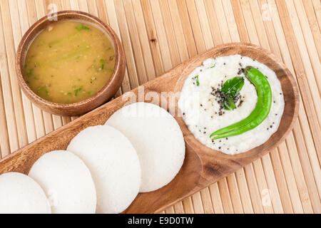 A traditional ethnic south Indian breakfast of Idly (Idli / rice cake) served with coconut chutney and sambar. Stock Photo