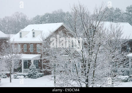A traditional, brick homes are captured during a snow storm in this beautiful, Winter scene. Stock Photo