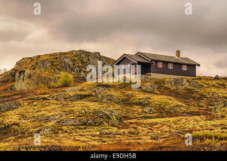 Cabin on a rocky hill in Hardangervidda National Park, Norway Stock Photo