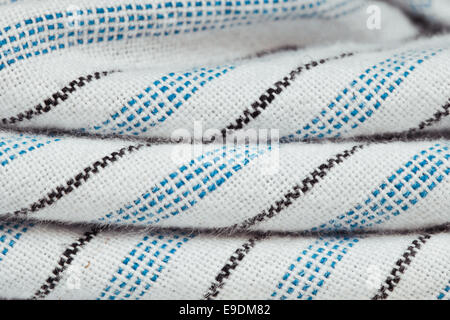 Folded blue, black and white striped cotton as a background