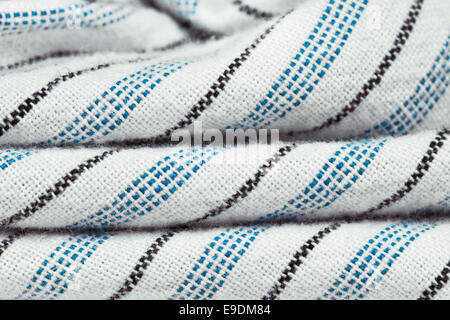 Folded blue, black and white striped cotton as a background Stock Photo