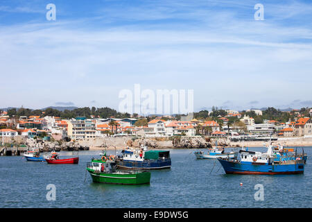 Houses and fishing boats moored at bay in resort town of Cascais, Portugal. Stock Photo