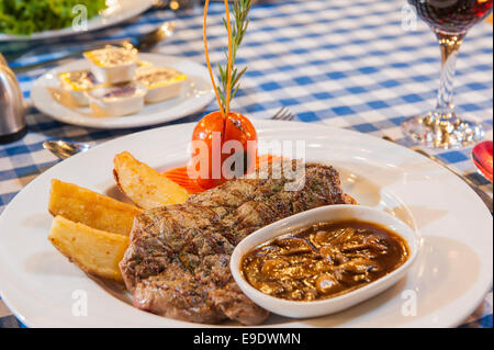 Beef steak a la carte meal with mushroom sauce on white plate Stock Photo