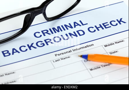 Criminal background check application form with glasses and ballpoint pen. Stock Photo