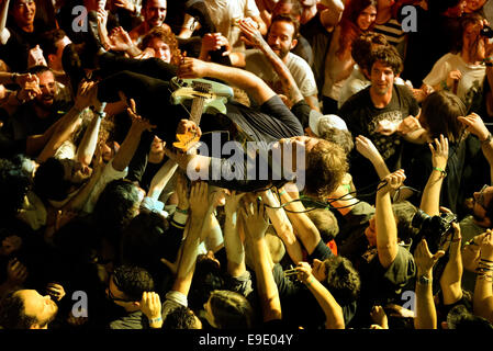 BARCELONA - MAY 30: The guitar player of Ty Segall (band) performs above the spectators (crowd surfing or mosh pit) at Heineken. Stock Photo
