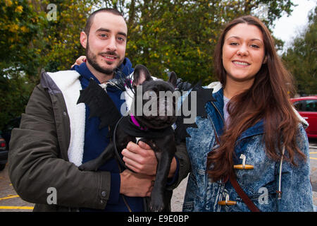 London, UK.  October 26th 2014. Dogs rescue and re-homing charity All Dogs Matter hold their annual Halloween fancy dress dog walk on Hampstead heath. PICTURED: Owners Myles and Miri with their French Bulldog Bean. Credit:  Paul Davey/Alamy Live News Stock Photo