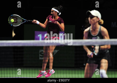 Singapore. 26th Oct, 2014. Sania Mirza (L) of India hits a return during the doubles final match of WTA Finals with Cara Black of Zimbabwe against Peng Shuai of China and Hsieh Su-Wei of Chinese Taipei in Singapore Indoor Stadium, Oct. 26, 2014. Cara Black and Sania Mirza won 2-0 to claim the champion. Credit:  Then Chih Wey/Xinhua/Alamy Live News Stock Photo