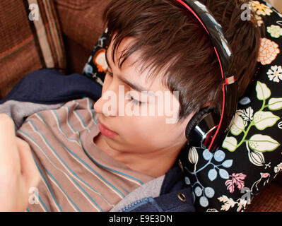 Boy  using headphones and gadget Stock Photo