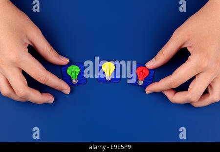 Three light bulbs on blue background with woman's hands. Pictures drawn by me. Stock Photo