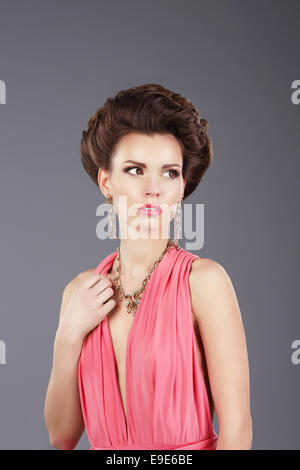 Stylish Lady in Pink Dress with Ornamentation Stock Photo