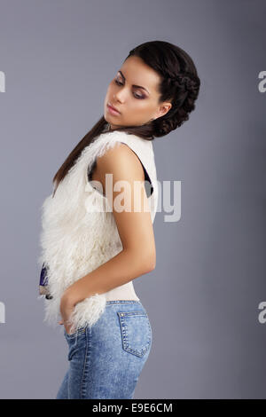 Trendy Woman in Sleeveless Jacket and Jeans Stock Photo