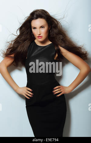 Gorgeous Lady in Black Evening Dress with Loosing Long Hairs Stock Photo