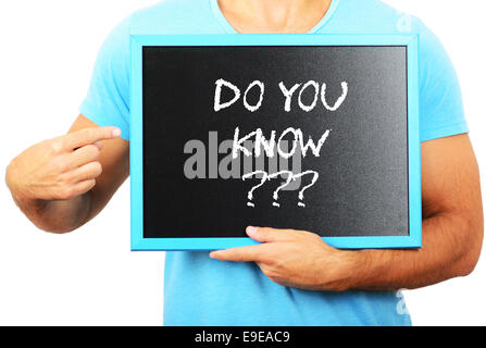 Man holding blackboard in hands and pointing the word DO YOU KNOW Stock Photo