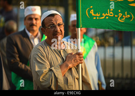 Cairo, Egypt. 26th Oct, 2014. Members of Egyptian sufi muslim group parade the street during a ritual to commemorate the Hijri New Year, also known as Islamic New Year, in Cairo on October 26, 2014. The Islamic year lasts for about 354 days and consists of 12 months. Muharram is the first month and some Muslims mark the start of the Islamic year on the first day of Muharram Credit:  Amr Sayed/APA Images/ZUMA Wire/Alamy Live News Stock Photo