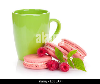 Pink raspberry macaroon cookies and cup of drink. Isolated on white background Stock Photo