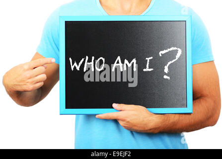 Man holding blackboard in hands and pointing the word WHO AM I Stock Photo