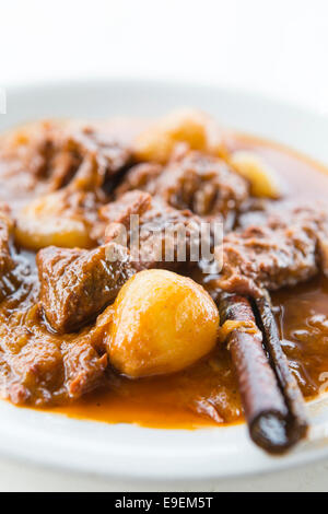 Traditional Beef Stifado with cinnamon on a white plate at Zakynthos, Greece Stock Photo