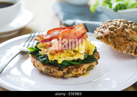 Bacon,scramble egg and steamed spinach on Pumpkin bread breakfast Stock Photo