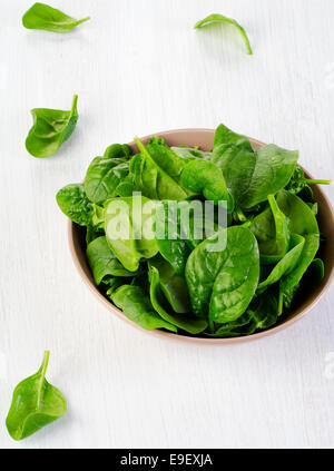 Fresh green spinach leaves on a wooden table Stock Photo