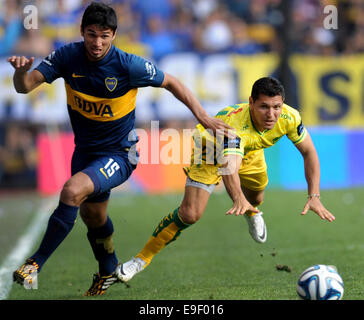 Buenos Aires, Argentina. 26th Oct, 2014. Leandro Marin (L) of Boca Juniors vies with Javier Yacuzzi of Defensa y Justicia during the match of the Argentinean First Division Tournament, at the Alberto J. Armando stadium, in Buenos Aires, Argentina, on Oct. 26, 2014. Credit:  Juan Roleri/TELAM/Xinhua/Alamy Live News Stock Photo