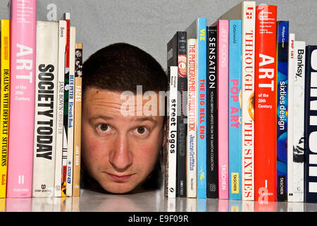 a man is book ended by art books Stock Photo