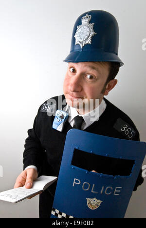 a man dressed in a silly fancy dress costume as an english policeman Stock Photo