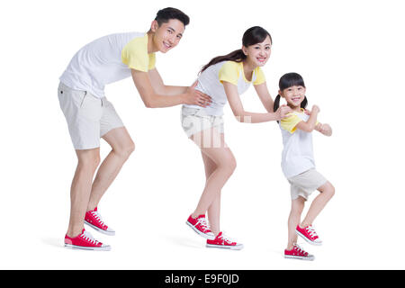 Happy young family walking in train formation Stock Photo
