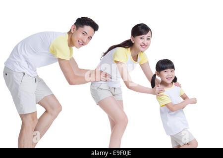 Happy young family walking in train formation Stock Photo