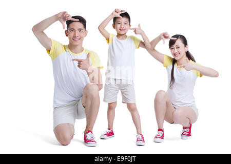 Happy young family making finger frame Stock Photo