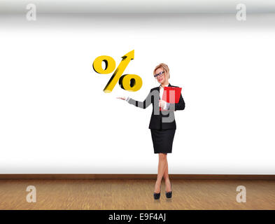 businesswoman holding percentage symbol in room Stock Photo