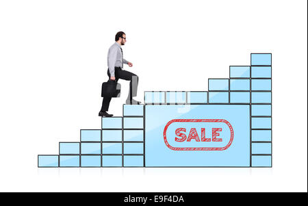 businessman walking up stairs of monitors with sale Stock Photo